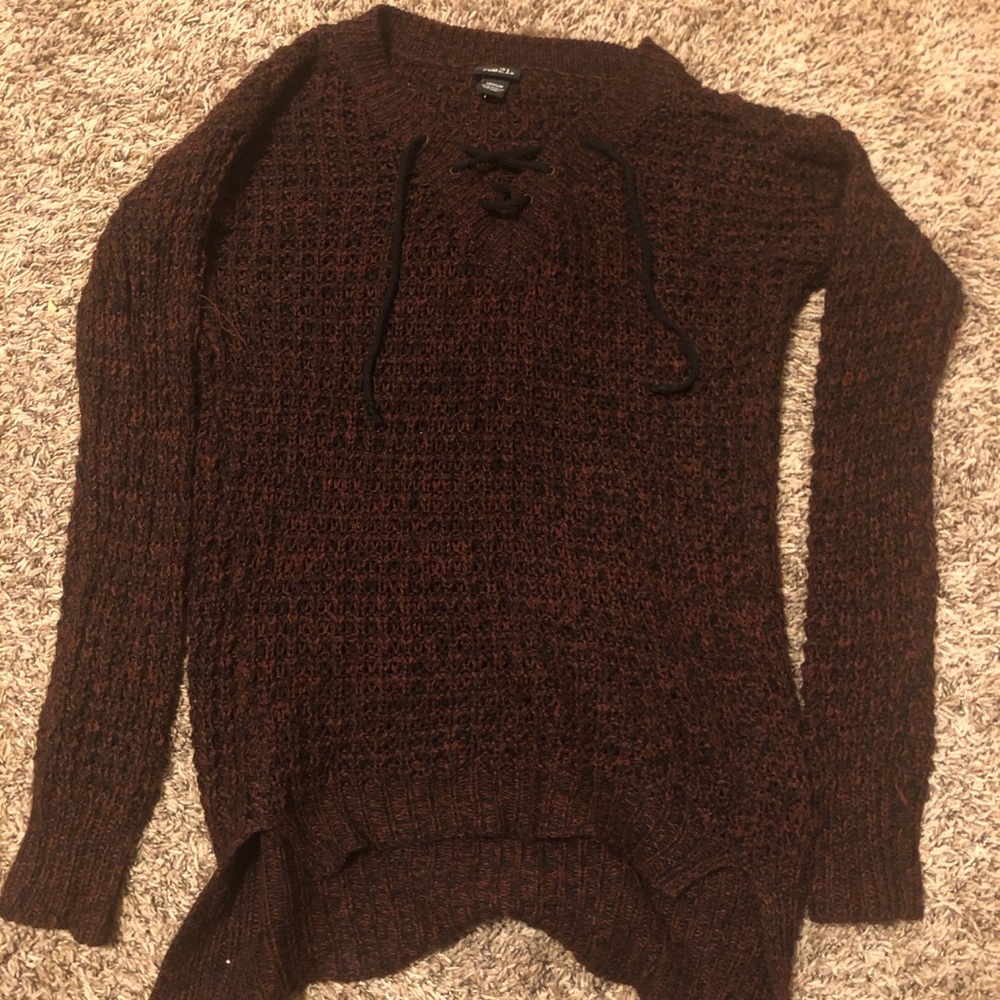 Dark red and black knitted sweater with lace up detail.